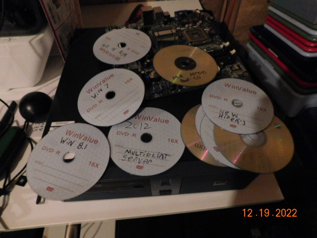 A pile of old optical discs from installing so many different OSes.