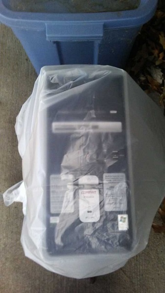 The Compaq computer, still stuck in a trash bag after I brought it home.